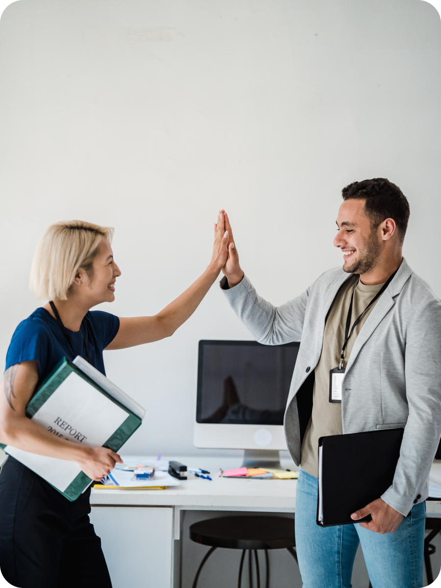 Colleagues clapping hands happily after finding the right insurance plan.