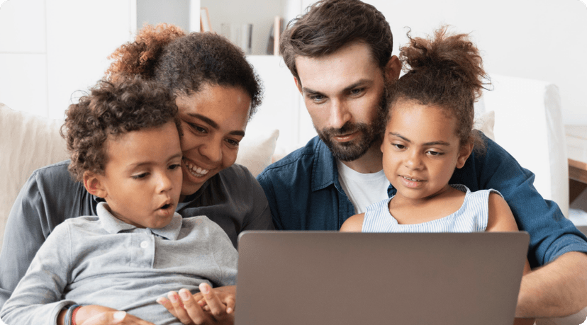 Family looking at a laptop.